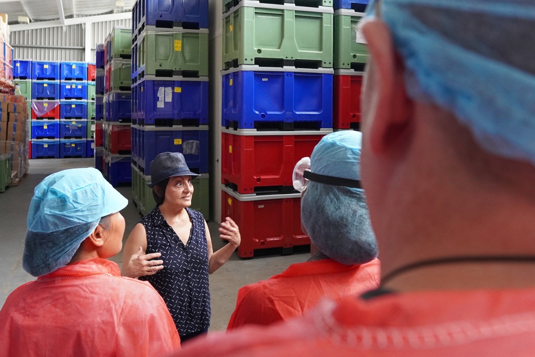 Food Accelerator programme participants touring Nim's Naturally factory, observing the production process with staff in protective gear