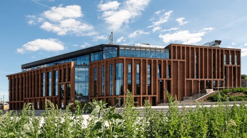 Verena Holmes: A modern industrial-style building with glass and bronze cladding